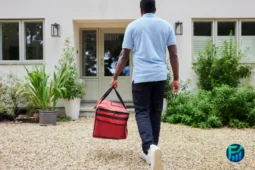 Delivery worker with a red food bag heading to a front door, a gig job where retirement savings without 401k access matters