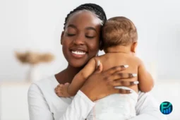 A smiling mother warmly hugging her baby, illustrating families navigating wic benefits eligibility.